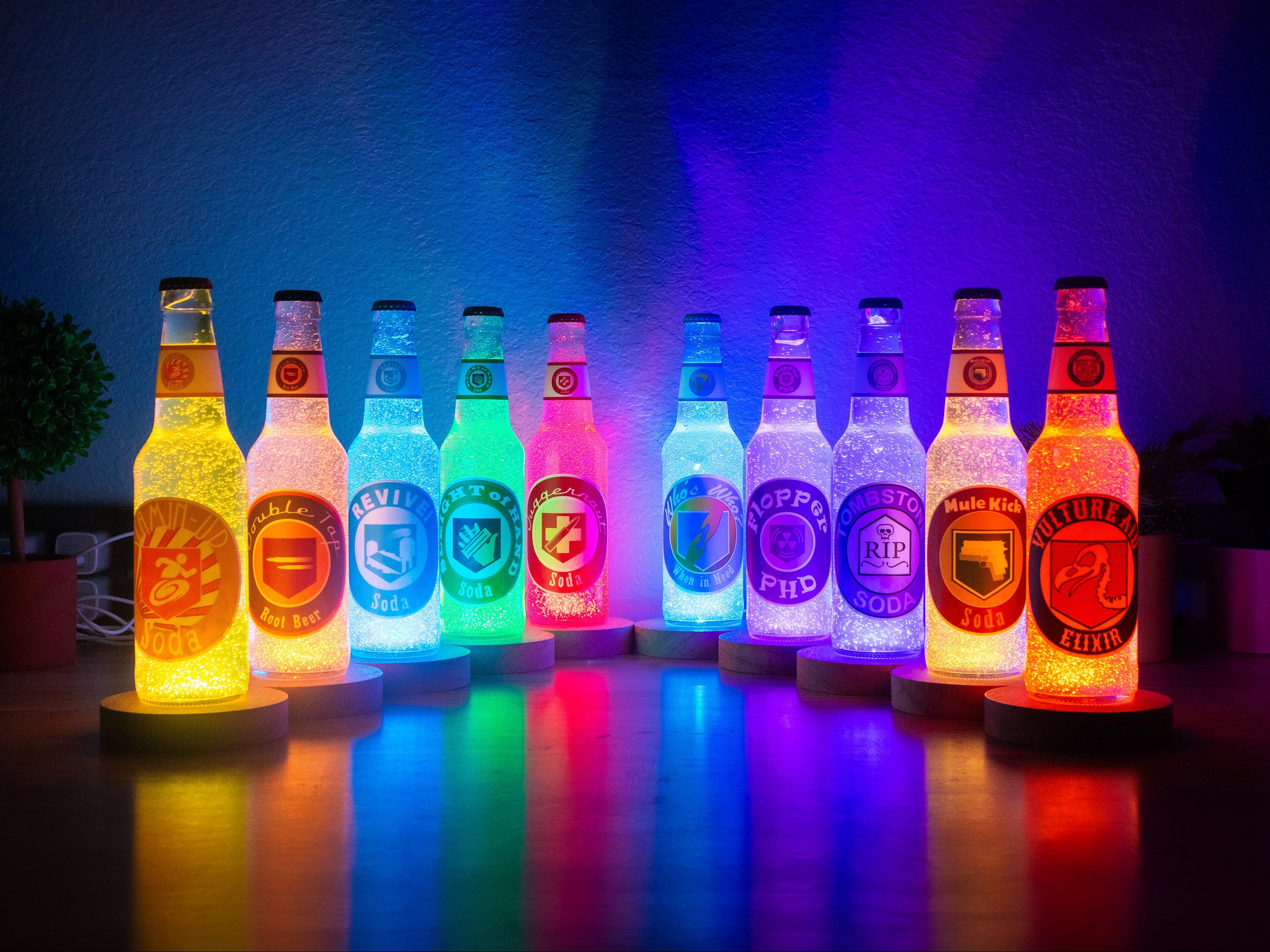 Row of colorful LED bottle lights on a dark background